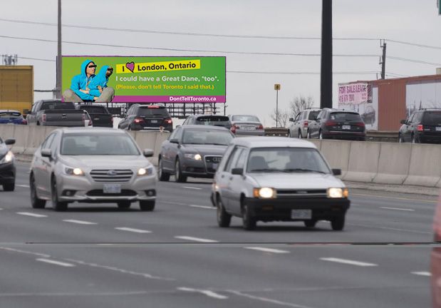 A digital billboard on highway 401 on the way to Toronto with Don't Tell Toronto Ad on it. 